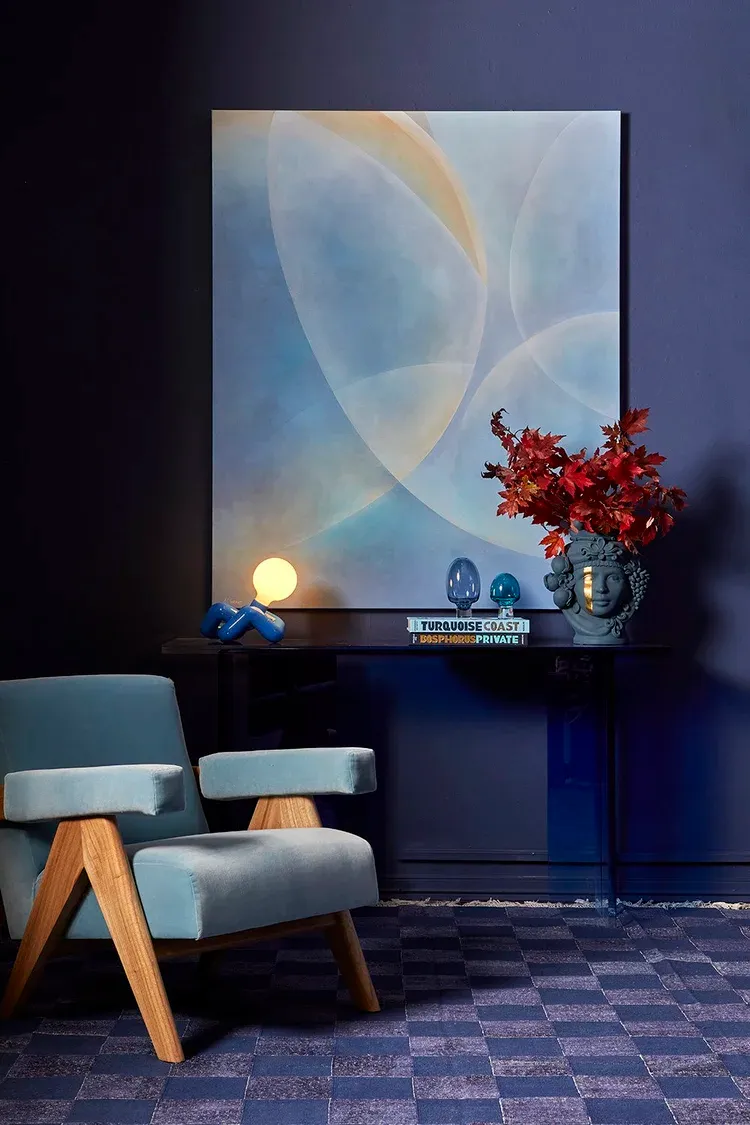 Shared Wavelengths, 2023 — a luminous geometric painting styled in a deep-blue interior
