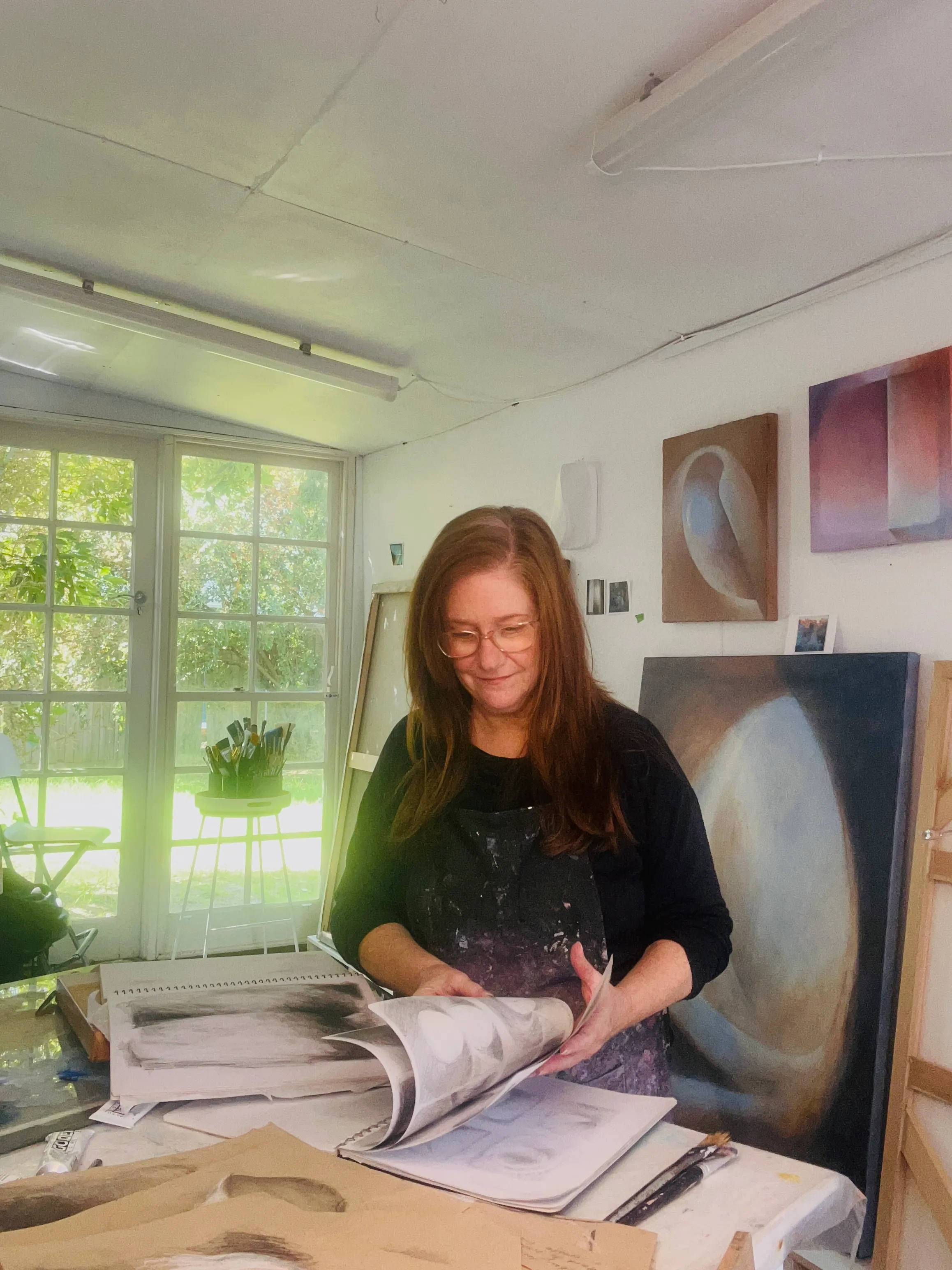 Michele Luminato in her Melbourne studio, working among her paintings